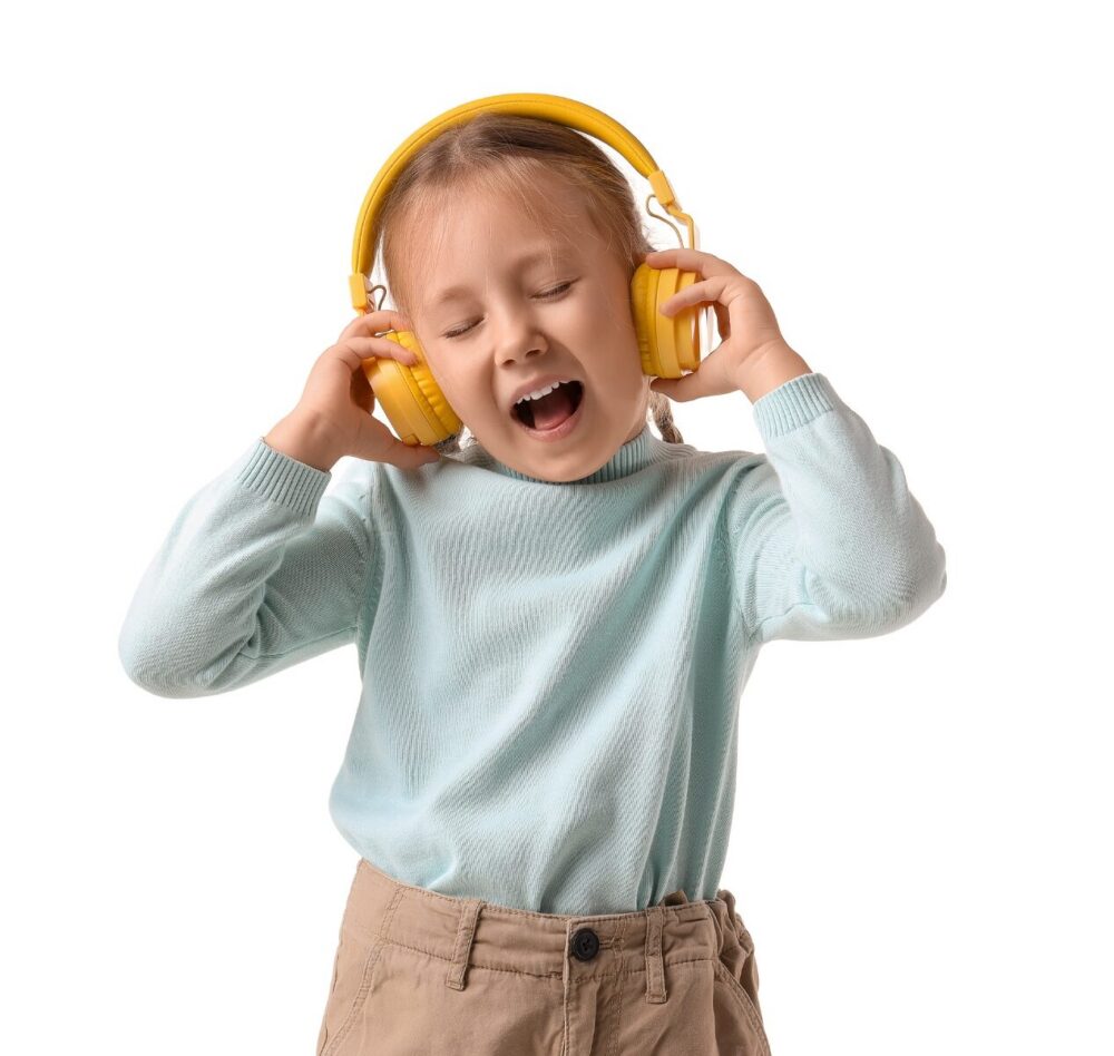 Child dancing and singing with headphones on
