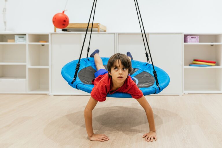 Child swinging on an indoor chair