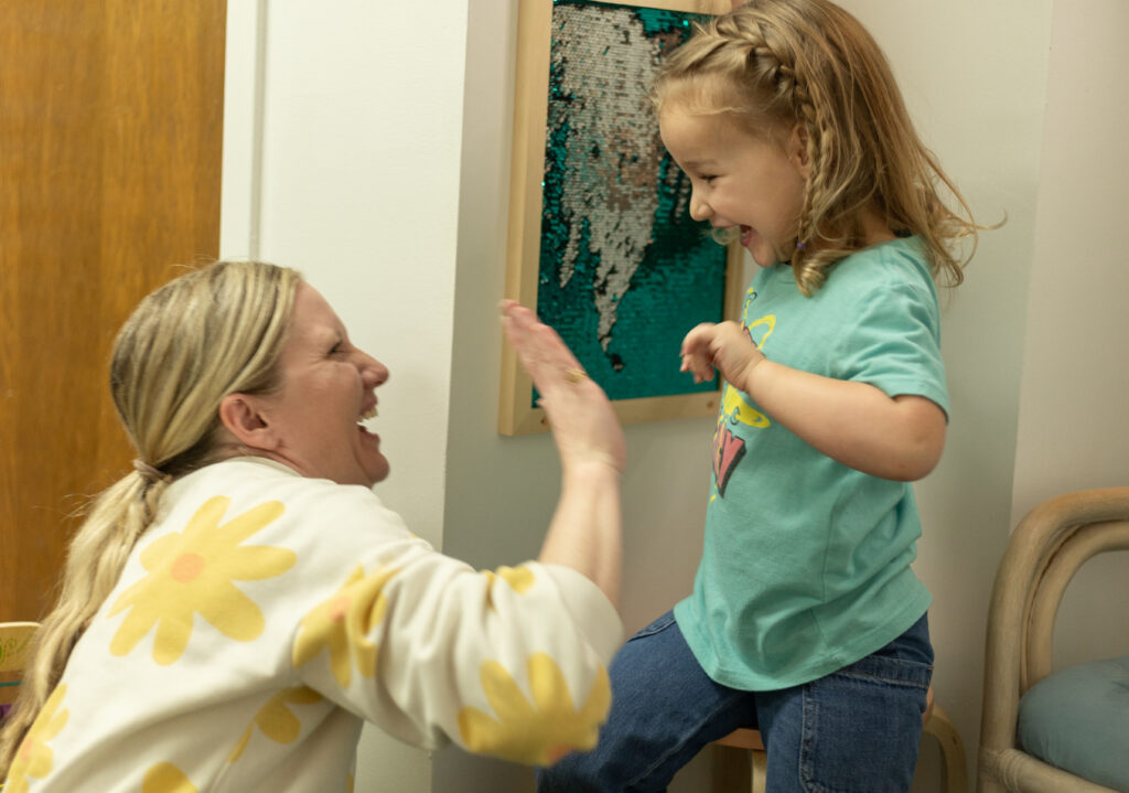 Therapist high fiving child